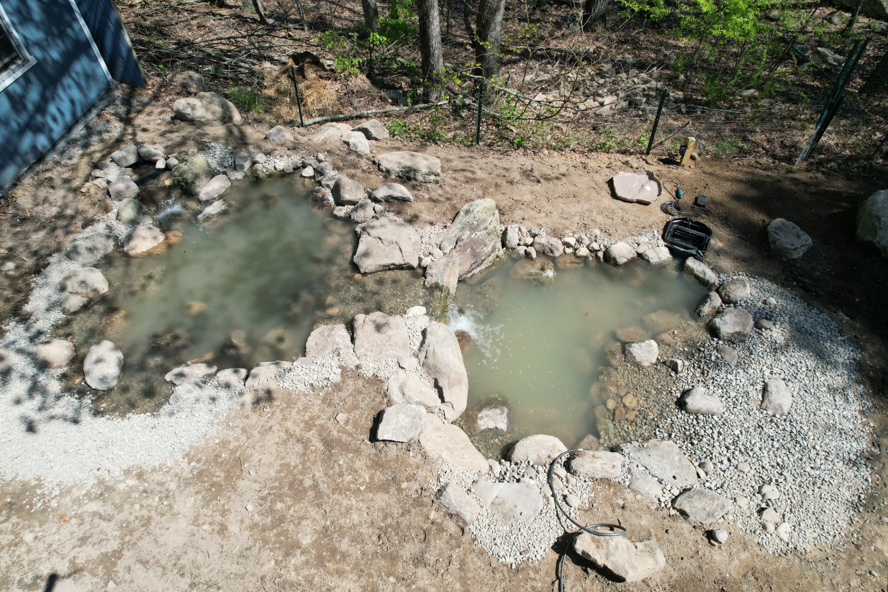 Krissy's backyard after — finished ecosystem pond with waterfall and rockwork