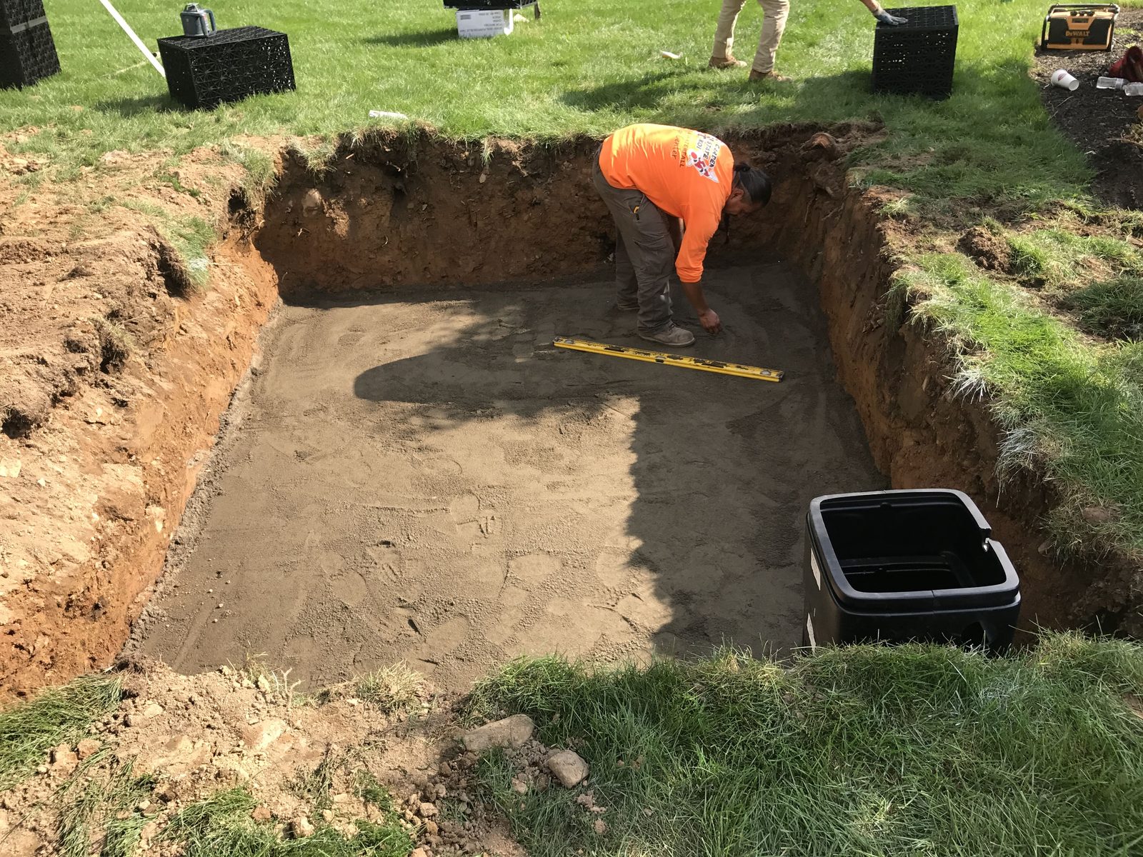 Garden State Koi crew excavating and plumbing a new backyard pond in New York