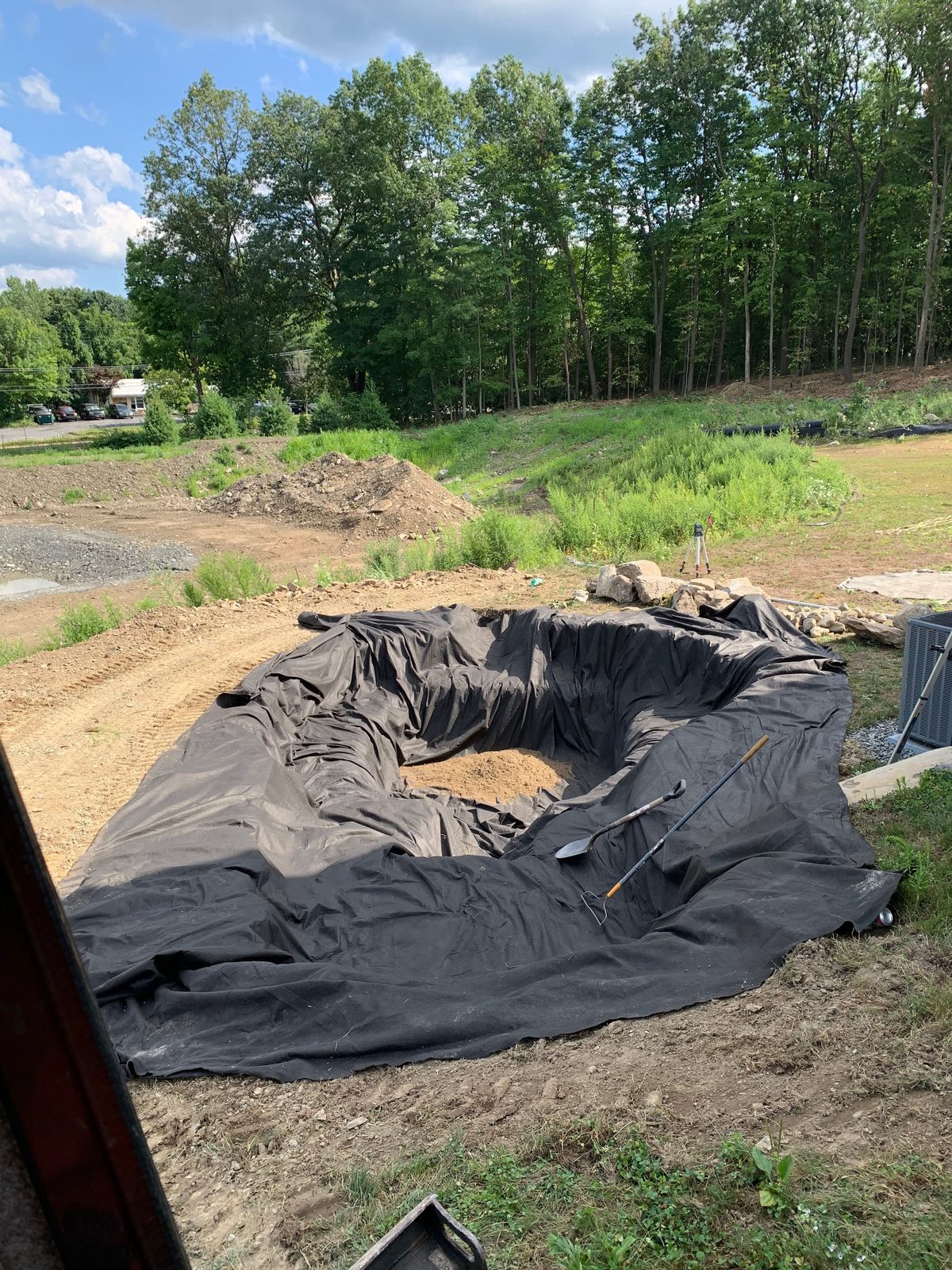 Pond liner installed in a new basin at the start of a pond build