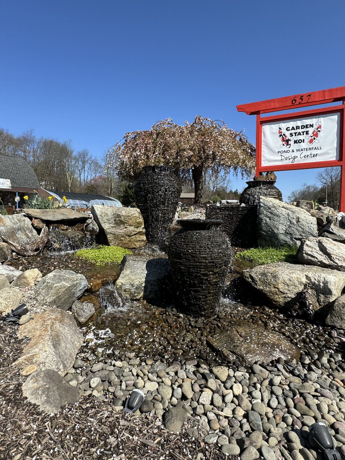 Pondless waterfall and fountainscape arranged among natural boulders and river rock