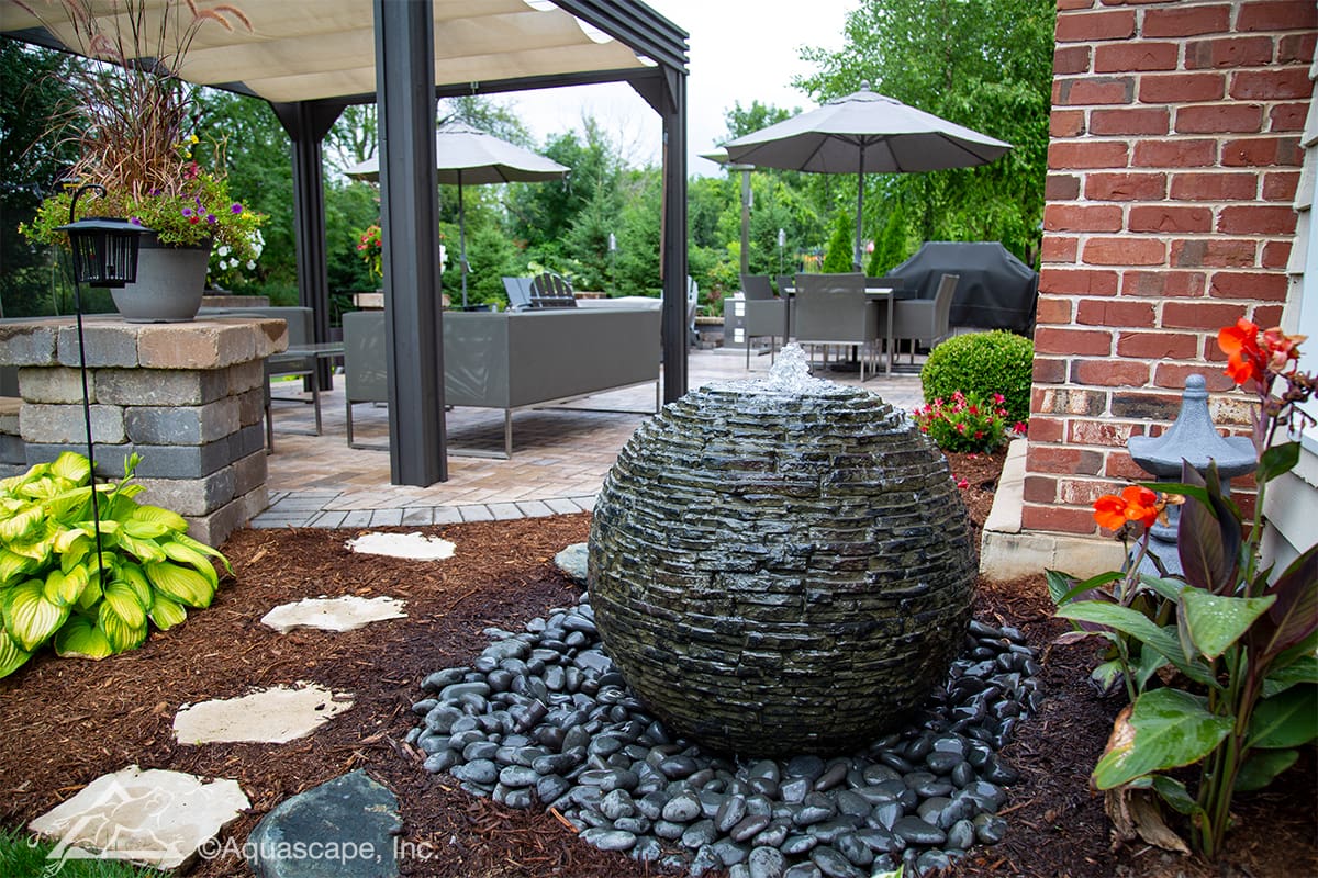 Stacked Slate Sphere fountain installed in landscape