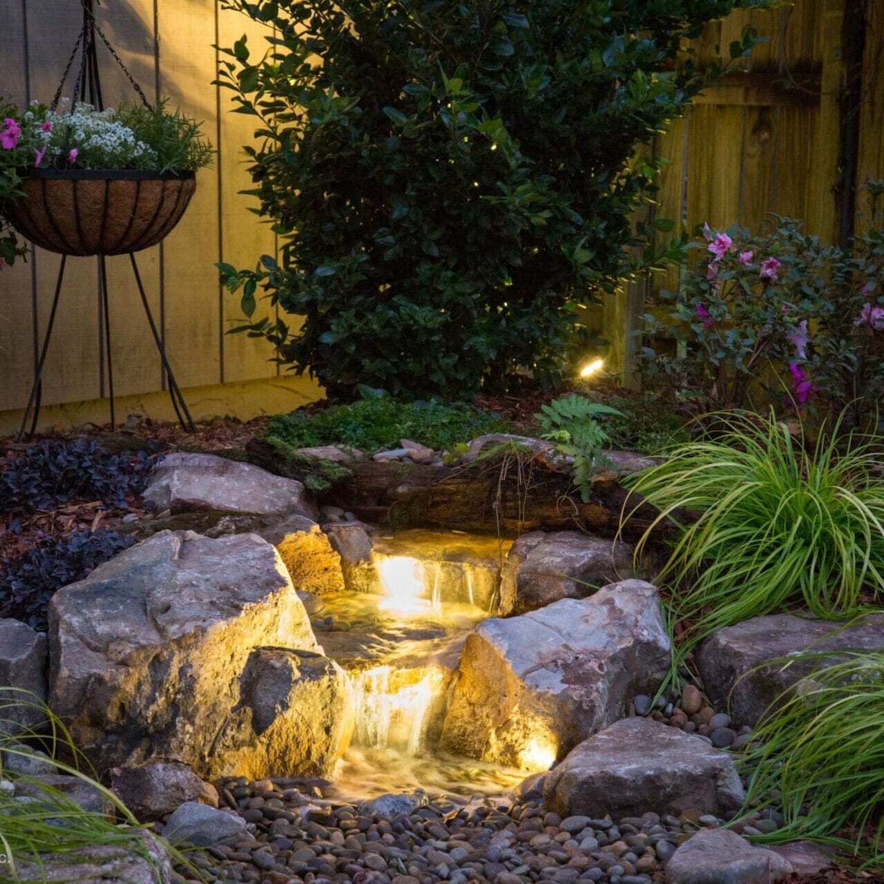 Backyard pondless waterfall with lighting