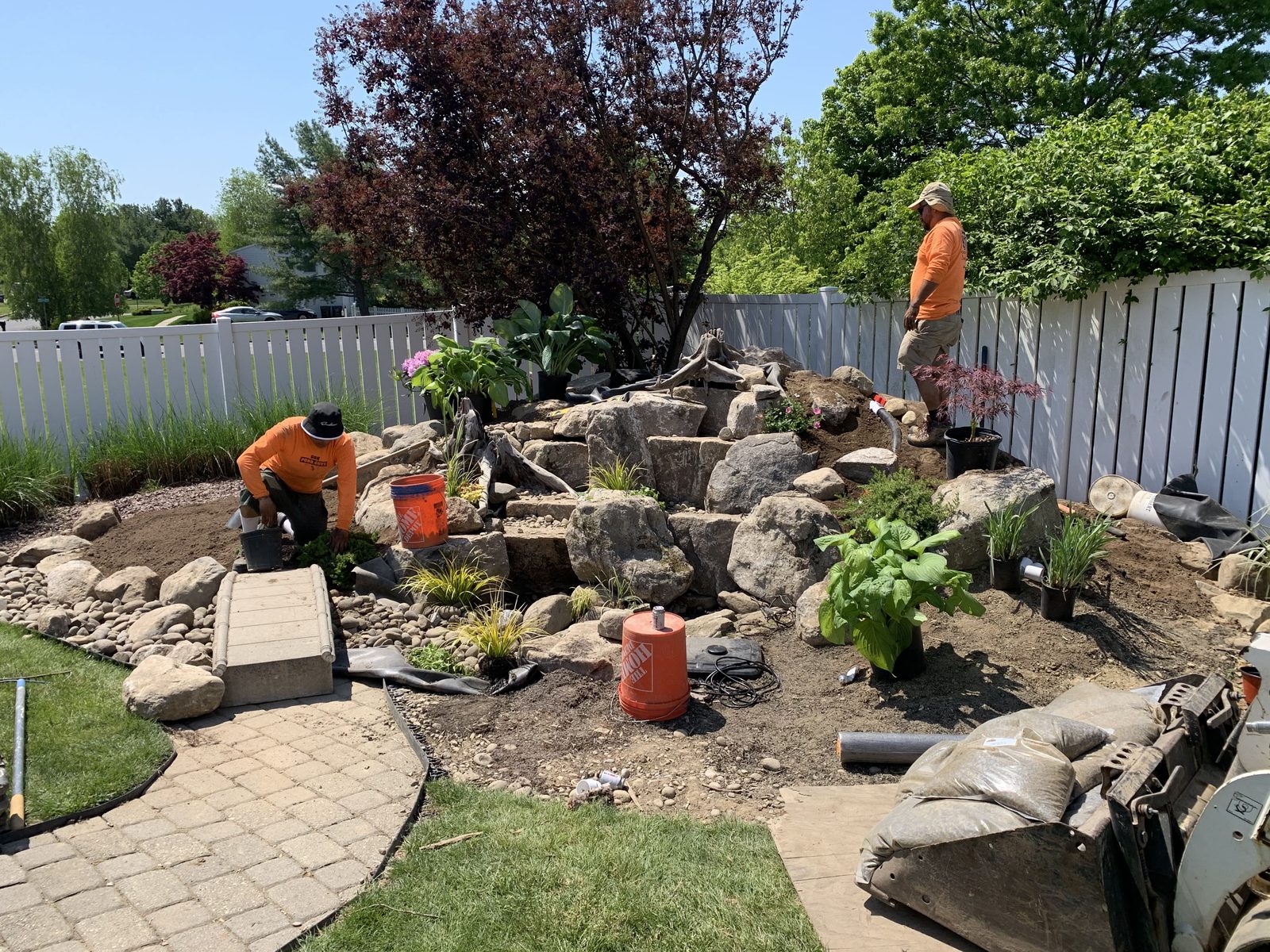 Garden State Koi crew setting boulders during a pond build