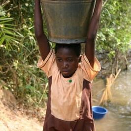 Foundation 18 Teen boy carrying water barrel over head